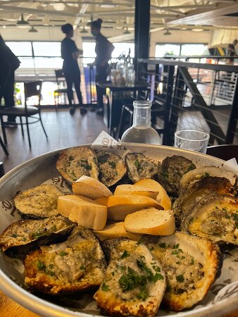 Ulele signature dishes Charbroiled Oysters, Alligator Hush Puppies, Florida Pompano, Native Sauté (often with duck or seafood), Ulele Light Beer.